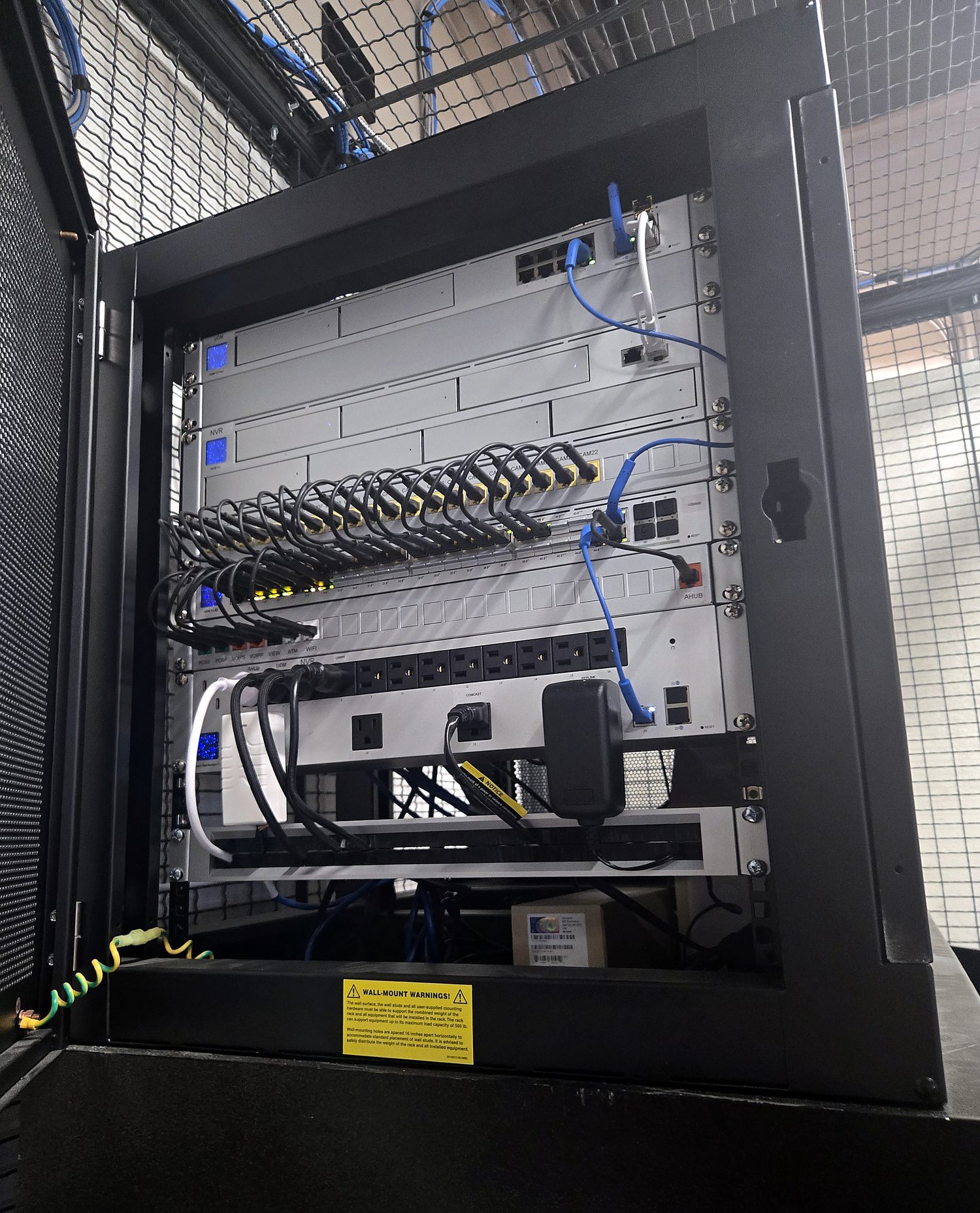 Finished Miclyn network rack from a separate project — organized switching, NVR, patch panels with neat cable management, fully deployed
