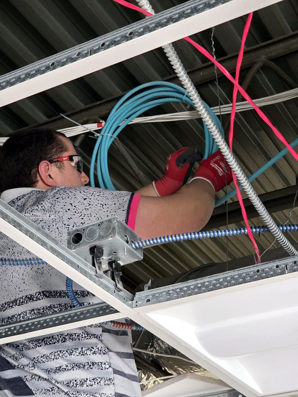 Miclyn technician installing cabling and infrastructure on a commercial job site