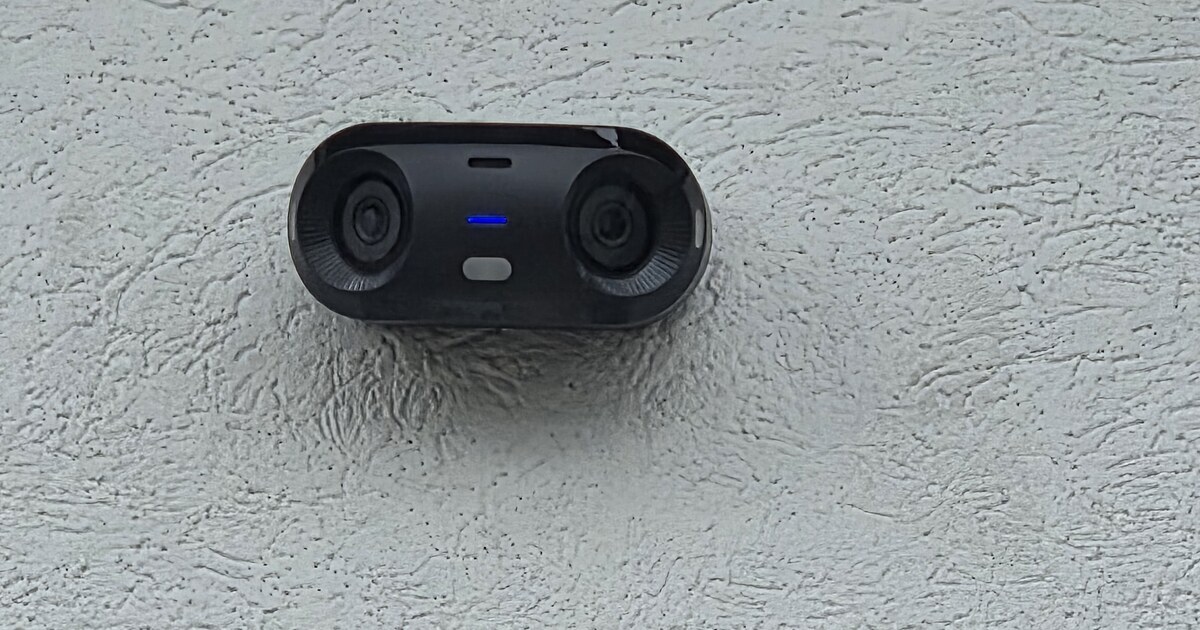 A business security camera mounted to monitor an entrance.